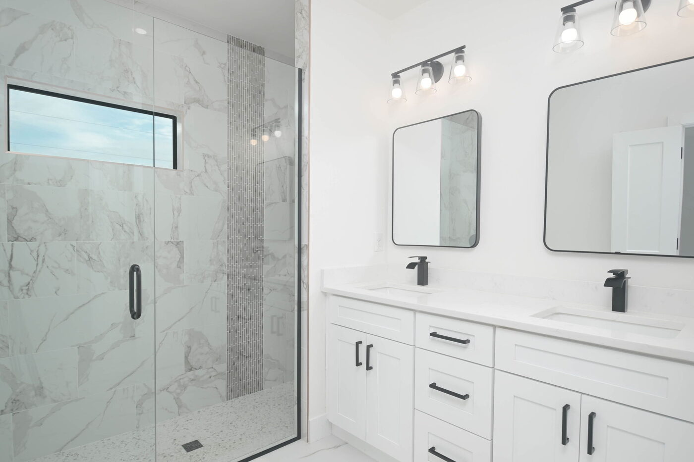 Modern bathroom with marble-look tile shower and double vanity